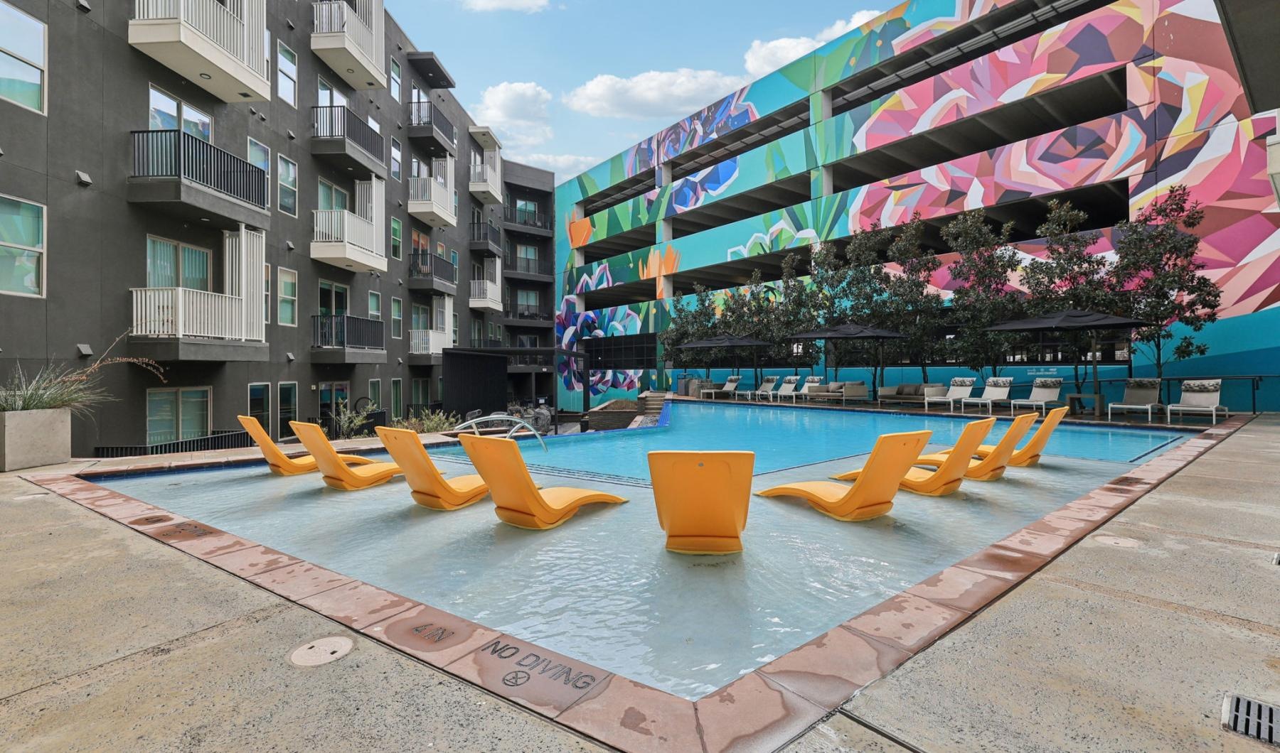 a row of yellow and blue chairs on a sidewalk